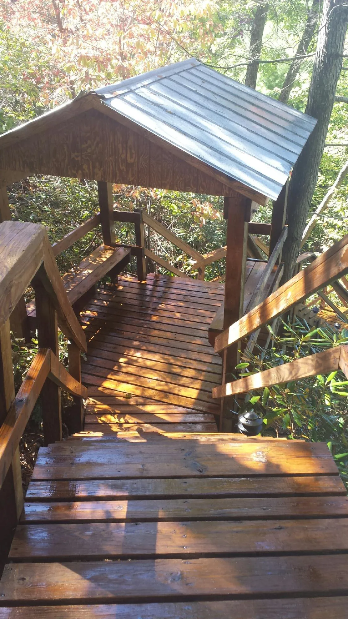 Freshly stained wood walkway and covered shelter with a metal roof in Crab Orchard